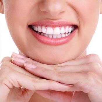 Restorative dentistry has left this woman's smile bright and shiny.